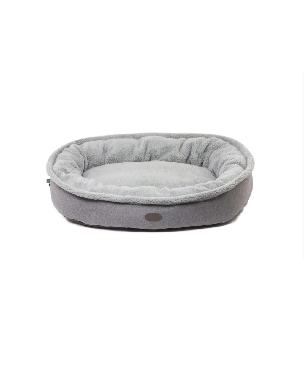 Furry bagel dog bed with faux shearling interior and velvet shell